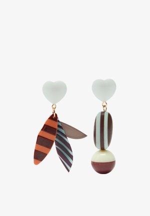 Asymetryczne kolczyki z białymi sztyftami w kształcie serca; jeden ma trzy wiszące elementy w kształcie paskowanych liści, drugi ma paskowaną owalną zawieszkę i półpaskowaną kulę.