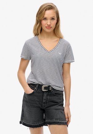Gestreiftes V-Ausschnitt-T-Shirt in Marineblau und Weiß, kombiniert mit schwarzen Jeansshorts mit fransigem Saum und einer dekorativen silbernen Gürtelschnalle.
