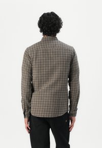 Men's long-sleeve plaid shirt in beige and brown tones with blue accents. Features button cuffs and a straight hem. Made of woven fabric.