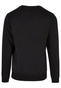 Sweat-shirt noir uni à manches longues avec poignets et ourlet côtelés, vu de dos sur fond blanc.