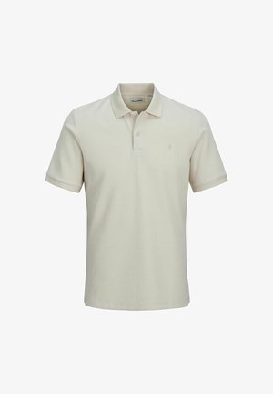 Μπεζ polo μπλούζα κοντομάνικη από υφασμένο υλικό με υφή. Διαθέτει κλείσιμο με δύο κουμπιά και μικρό λογότυπο στο αριστερό στήθος.