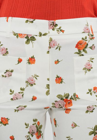 Floral trousers featuring a white fabric with pink and orange rose patterns, straight cut, and two front pockets.