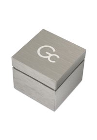 Grey metal box with a brushed texture, featuring a white "Gc" logo on the top. Square shape, smooth edges, and a lift-off lid.