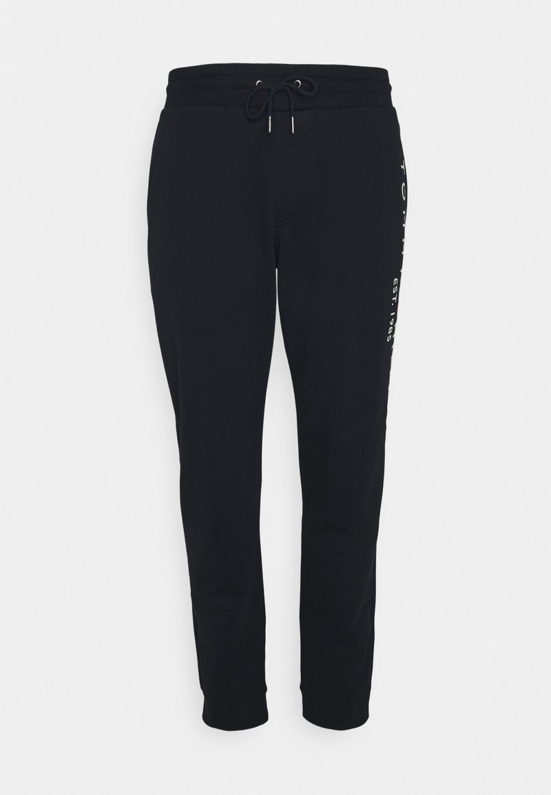 Black sweatpants made of soft fabric, featuring a drawstring waistband, tapered leg design, and printed logo detail on the side.