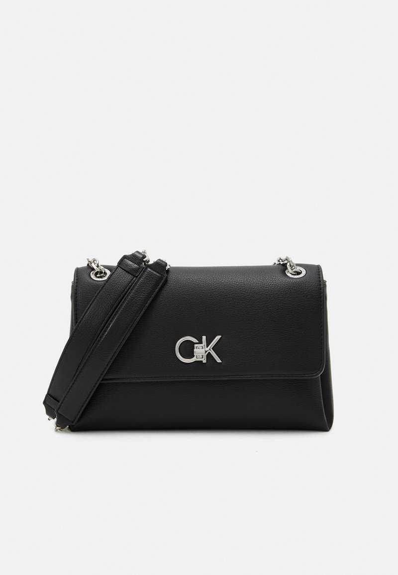 Black leather handbag with a silver logo detail, rectangular shape, flap closure, and detachable strap for shoulder or crossbody wear.