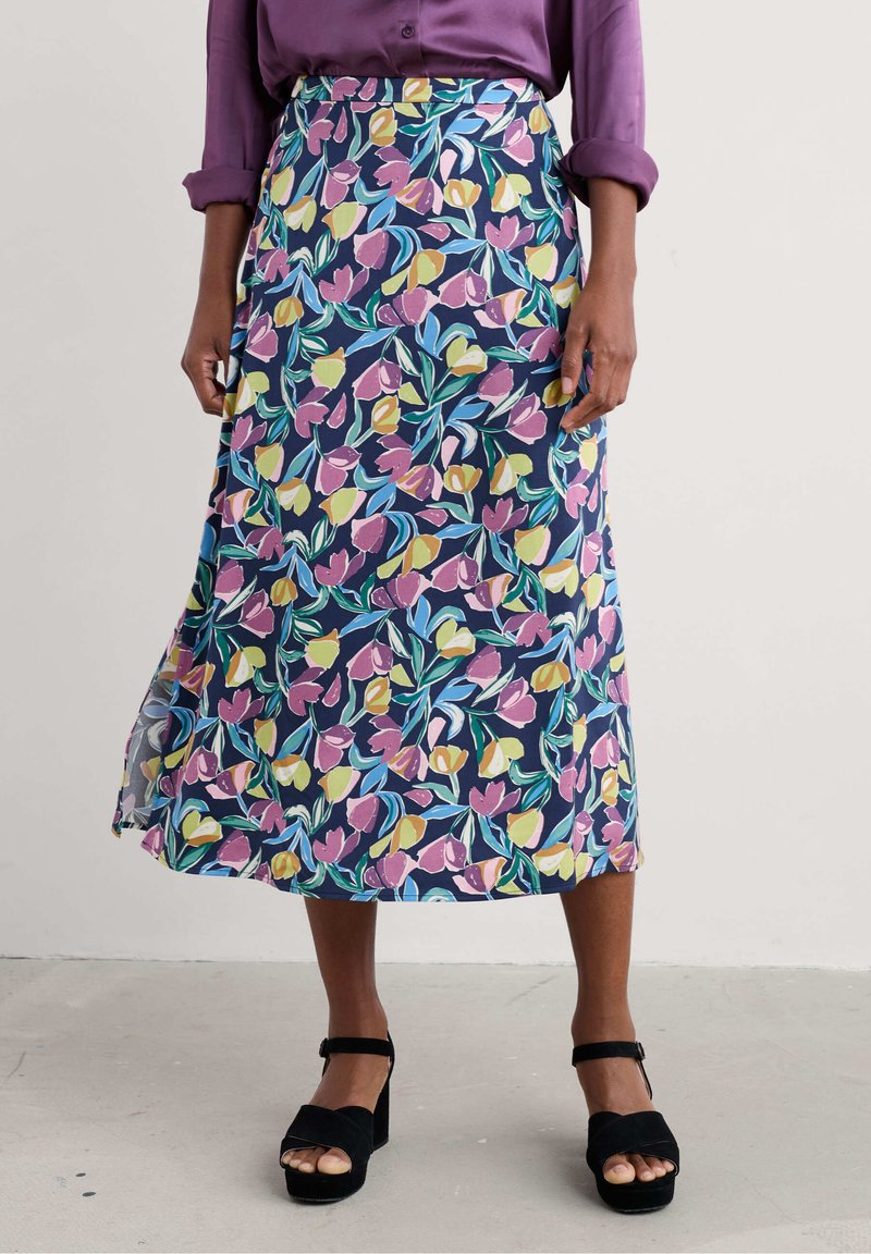 Floral skirt featuring a navy background with yellow, pink, and green tulip patterns. The fabric is lightweight and flows to mid-calf.