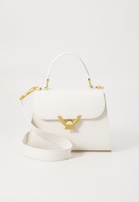 White textured leather handbag with a top handle, adjustable strap, and a gold-tone hardware closure featuring a v-shaped accent.