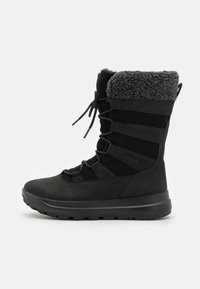 Svart vanntett støvel med semsket ytre, fleece-fôret krage og elastiske snører. Har en teksturert gummisåle for grep og støtte.