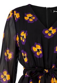 Robe noire avec un décolleté en V, de longues manches transparentes et une ceinture à nouer. Présente des motifs floraux vibrants en jaune et violet sur le tissu.