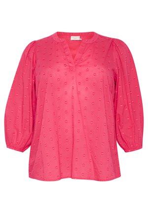 Rosa Bluse mit V-Ausschnitt, Puffärmeln und strukturierten Herzmustern auf dem Stoff. Hergestellt aus leichtem, atmungsaktivem Material.