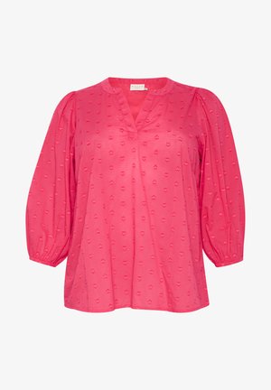 Bluză roz cu decolteu în V, mâneci bufante și modele texturate în formă de inimă pe întreaga țesătură. Fabricată dintr-un material ușor și respirabil.