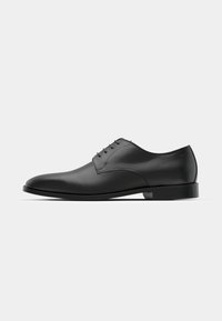 Black leather dress shoe with a rounded toe, five eyelet lace-up design, smooth surface, and a low, flat heel.