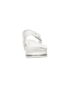 White sandals with a textured synthetic upper, adjustable strap with a buckle, and a low, cushioned sole. Front view showcases design details.