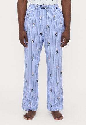 Pantaloni da pigiama azzurri con strisce bianche verticali, decorati con piccole illustrazioni di orsetti colorati. Vita elastica con cordoncino.