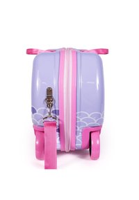 Purple hard-shell luggage with pink accents, smooth texture, two wheels, a zipper closure, and a detachable pink strap. Cloud patterns on the base.