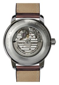 Edelstahl-Gehäuseboden mit automatischem Mechanismus, sichtbaren Zahnrädern, einem goldenen Rotor und einem glatten Lederarmband in Braun und Beige.