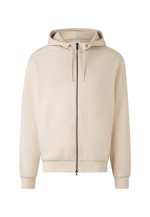 Beige Zip-Hoodie aus weichem Material, mit Kordelzugkapuze, gerippten Bündchen und Saum, in einem schlanken, minimalistischen Design.
