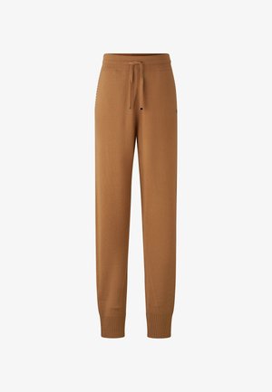 Brown knit joggers with an elastic waistband, drawstring, and ribbed cuffs. Smooth texture, featuring small logo details on the side.