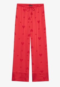 Pantaloni da pigiama rossi con elastico in vita e cordoncino. Presentano un motivo di cuori rossi di diverse dimensioni. Tessuto dalla consistenza liscia.