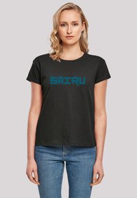 Black cotton t-shirt featuring a turquoise graphic text design with block letters. Short sleeves and a round neckline complete the look.