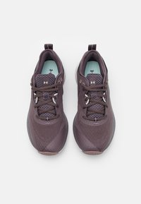 Purple athletic shoes with a breathable mesh upper, padded collar, subtle branding, and textured sole for grip. Includes laces and pull tab.