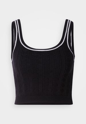 Svart strikket crop top med teksturert mønster, firkantet halslinning og kontrasterende hvit kant på stropper og nederkant.