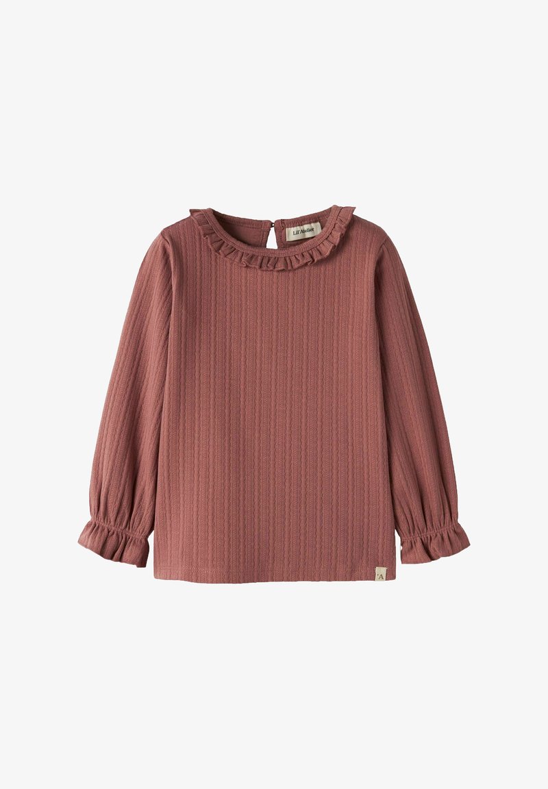 Haut côtelé rose poudré à manches longues avec encolure et poignets à volants, petite fermeture par bouton au dos et étiquette en tissu près de l’ourlet.