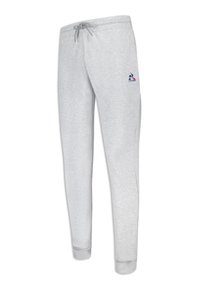 Gray sweatpants made of soft fabric, featuring a drawstring waistband, tapered legs, and a small logo in blue and red on the left side.
