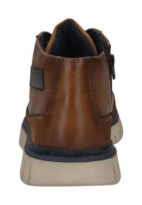 Braune Lederstiefelette mit strukturiertem Finish, runder Zehenpartie und einem Reißverschluss an der Seite. Mit einer hellen Gummisohle und Stofffutter ausgestattet.