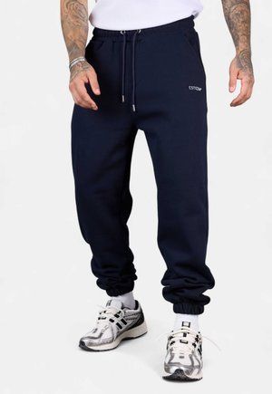 JOGGER ESSENTIAL - Tracksuit bottoms - darksapphire