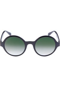 Lunettes de soleil rondes noires avec des verres dégradés verts et une monture mate. Présentent des branches épaisses et lisses ainsi qu'un logo discret sur le verre.