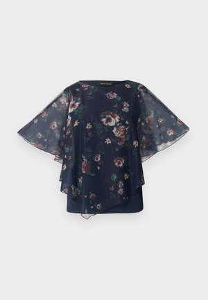 Marineblaue Bluse mit durchsichtigem, fließendem floralen Überwurf und breiten, flatternden Ärmeln, verziert mit pinken und weißen Blumen sowie grünen Blättern.