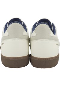 Sneakers bianchi e grigi con accenti blu, texture in pelle liscia e suede, forma arrotondata e suole in gomma marrone. Nome del marchio visibile sul tallone.