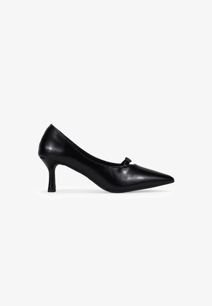 Black leather high heel shoe with a pointed toe and a small decorative bow feature on the front. Slim heel and smooth texture.