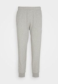 Ljusgrå joggingsbyxor i mjukt tyg, med elastisk midja och smalnande nederkant. Subtil logotypdetalj på sidan.