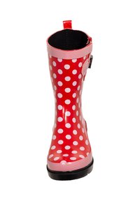 Red rubber rain boot with white polka dots, a striped cuff, and a black sole. Features a side strap for adjustment and a pull tab.