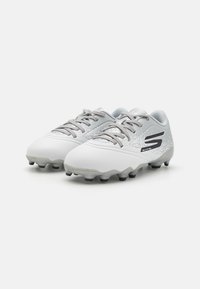 White soccer cleats with a textured upper, gray laces, and a black logo. Features a molded sole with black studs for traction.