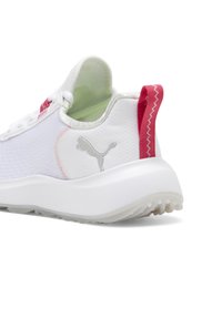 White athletic shoe featuring a textured synthetic upper, pink accents on the heel, and a cushioned white sole with traction elements.