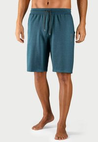 Teal sportieve shorts van zacht materiaal, met een elastische tailleband en een trekkoord, en een klein logo aan de zijkant.