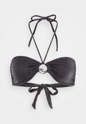 Black bikini top with a sparkling texture, bandeau style, ties at the neck and back, featuring a circular metallic accent at the center.