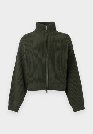 Knitted cropped sweater in dark green with a high collar and zip front. Features wide sleeves and ribbed texture throughout the fabric.