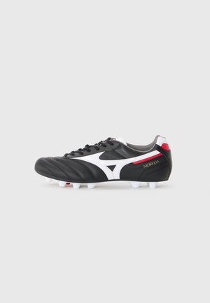 Black leather soccer cleat with white accents and red details. Features a rounded toe, stitched texture, and white molded studs on the sole.