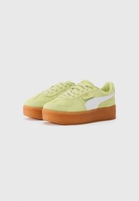 Lime green suede sneakers with a white PUMA logo, rounded shape, flat laces, and a thick gum rubber sole.