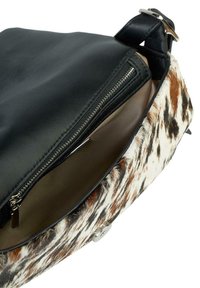 Borsa a tracolla in pelle nera e pelle di mucca con motivo, con chiusura a zip e interno morbido color beige. Rifinita con dettagli in metallo argentato.