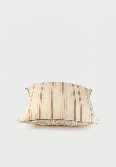 Coussin rectangulaire avec des rayures verticales beiges et marron et des motifs cachemire, posé à plat sur un fond clair.