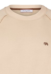 Beige sweatshirt med rund hals, prydet med et lille brunt elefantlogo på brystet. Fremstillet af blødt stof med en ribbet tekstur.