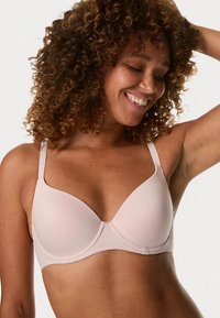 Reggiseno rosa chiaro con coppe sagomate e lisce e spalline regolabili. Tessuto morbido con design senza cuciture per il massimo comfort. Ferretto leggermente curvo.