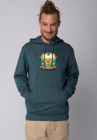 Türkiser Hoodie mit einer Fronttasche und Kordelzügen, ausgestattet mit einem bunten Grafikdesign eines Vans, der Friedenssymbole und florale Motive zeigt.
