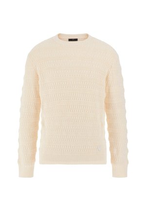 Cremfarbener Strickpullover mit strukturiertem Muster, gerippten Bündchen und Saum sowie einem kleinen dreieckigen Akzent nahe dem unteren Saum.