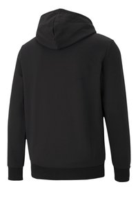 Svart hettegenser med strukturert stoff, lange ermer og snor i huen. Ribbestrikkede mansjetter og nederkant. Enkel design uten synlige mønstre.